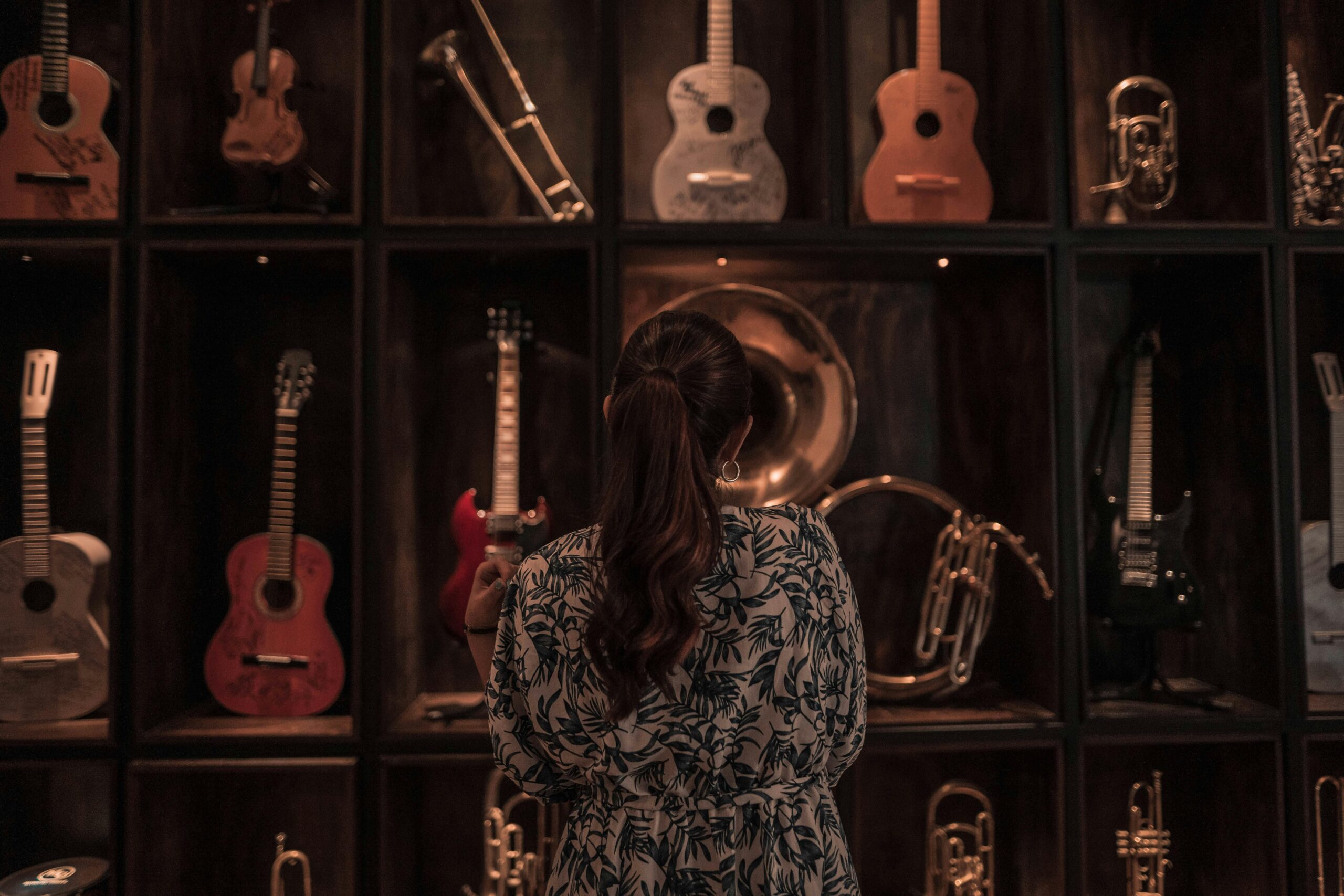 Woman looking at a variety of musical instruments