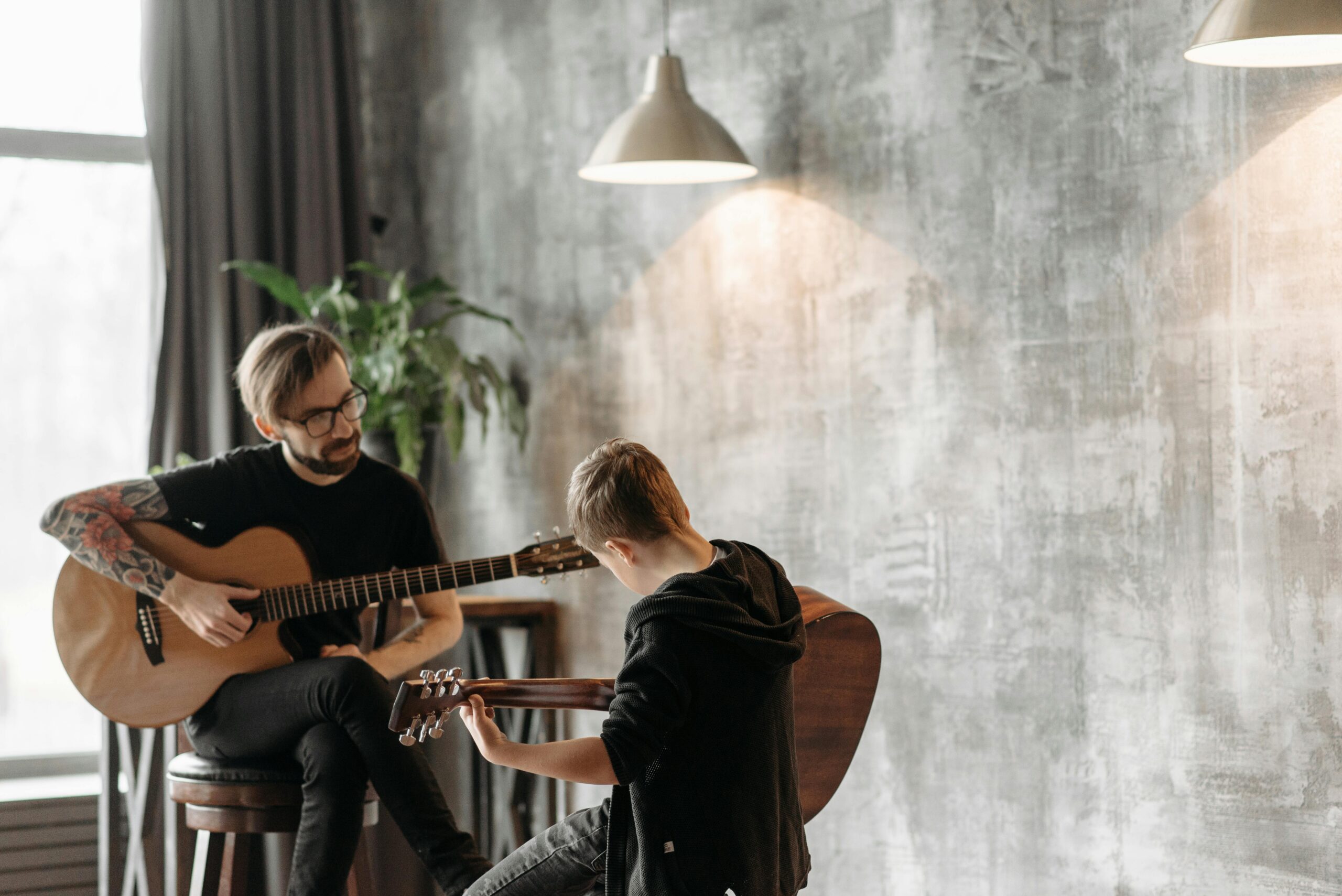 Teacher and student playing guitar